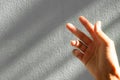 Finger woman with dark shadow of light day and cement wall background. card poster for clutch, stray couple, loss, disappointed