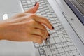 The finger of a woman`s hand on the laptop keyboard and presses the `Enter` key. Royalty Free Stock Photo