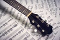 Fingerboard acoustic guitar on a background sheet notes Royalty Free Stock Photo