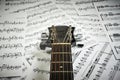 Fingerboard acoustic guitar on a background sheet notes Royalty Free Stock Photo