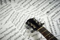 Fingerboard acoustic guitar on a background sheet notes Royalty Free Stock Photo