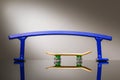 Fingerboard and blue metal railings designed for riding small skateboards