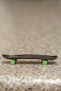 Fingerboard on a neutral background of marble surface, selective focus. A skateboard for finger skating and performing tricks alon