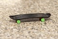 A fingerboard on a neutral blurred background of a marble surface, close-up, selective focus. A skateboard for finger skating and