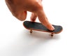 Fingerboard. A small skateboard and a hand. Close up. Isolated on white background