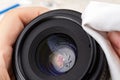 Fingerprint on a front camera lens close-up. Hands wiping a lens rim with a microfiber cloth before cleaning the greasy stain on a Royalty Free Stock Photo