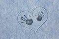 fingerprint on the snow. Three tracks from hands on the snow in painted heart. Love in the winter. Royalty Free Stock Photo