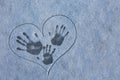 fingerprint on the snow. Three tracks from hands on the snow in painted heart. Love in the winter. Mom, Dad and baby. Royalty Free Stock Photo