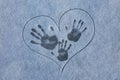 fingerprint on the snow. Three tracks from hands on the snow in painted heart. Love in the winter. Mom, Dad and baby. Royalty Free Stock Photo