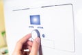 Fingers adjust Gas boiler control panel for hot water and heating. Buttons and a digital display. ÃÂ¡oncept of home heating and Royalty Free Stock Photo