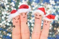 Fingers art of couple celebrates Christmas in New Year hats. Royalty Free Stock Photo