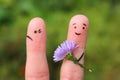 Fingers art of couple. Joyful man gives woman bouquet of flowers, she is not satisfied