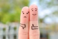 Fingers art of couple. Woman showing thumb down and man showing thumb up. Concept of disagreement in family