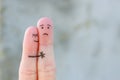 Fingers art of displeased couple. Man is sad, woman reassures her. She kisses and hugs hes Royalty Free Stock Photo