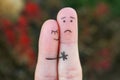Fingers art of displeased couple. Man is sad, woman reassures her. She kisses and hugs hes