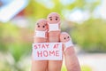 Fingers art of family with face mask is sitting in quarantine at home. People hold placard stay at home Royalty Free Stock Photo