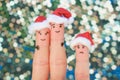 Fingers art of happy couple laughing in New Year hats. Man and woman hugs. Child is angry. Royalty Free Stock Photo