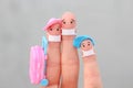 Fingers art of happy family with face mask. Man and woman going on vacation Royalty Free Stock Photo
