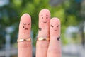 Fingers art of people. The husband kisses another woman, the wife is jealous