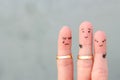 Fingers art of people. The husband kisses another woman, the wife is jealous