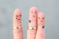 Fingers art of people. The husband kisses another woman, the wife is jealous