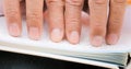 Fingers Of Blind Man Touching Page On Braille Book