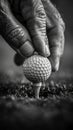 Fingers delicately holding a golf ball Royalty Free Stock Photo