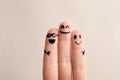 Fingers with drawings of happy faces