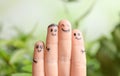 Fingers with drawings of happy faces