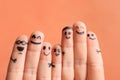 Fingers with drawings of happy faces