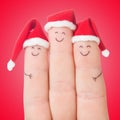 Fingers faces in Santa hats. Happy family celebrating