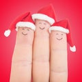 Fingers faces in Santa hats. Happy family celebrating concept