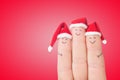 Fingers faces in Santa hats. Happy family celebrating