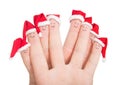 Fingers faces in Santa hats.