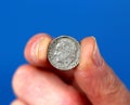 Fingers hold old Roosevelt Dime Coin Royalty Free Stock Photo
