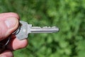 fingers hold one gray old metal door key Royalty Free Stock Photo