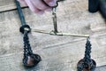 Fingers hold retro scales on a chain. Old scales for weighing gold and coins