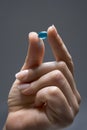 Fingers Holding A Blue Capsule Royalty Free Stock Photo