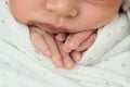 Fingers of a newborn baby, toes in the hands of mom and dad, hands and nails of a child, the first days of life after birth Royalty Free Stock Photo