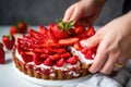 fingers picking up a single-serve strawberry tart