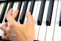 Fingers play chords on piano keys playing synthesizer pianist music hobby