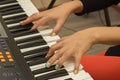 Fingers playing electronic piano keyboards Royalty Free Stock Photo