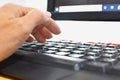 Fingers to keyboard on the laptop to working from home with business communications working with selective focus on Royalty Free Stock Photo