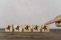 Fingers touching a wooden block depicts a businessman walking his career progression on a wooden block Royalty Free Stock Photo