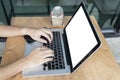 Fingers typing on the computer keyboard and cell phone on desk. Royalty Free Stock Photo