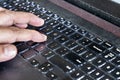 Fingers typing on laptop computer keyboard laced with dusk, particles and is very unhygienic and unhealthy Royalty Free Stock Photo