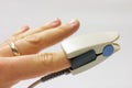 Fingertip pulse oximeter sensor placed on finger