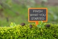 Finish what you started text on small blackboard