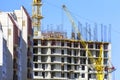 Finished Apartment Building and a New High-Rise Building Construction Site with Yellow Cranes against Blue Sky. Real Estate, Royalty Free Stock Photo