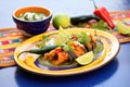 finished chiles rellenos dish garnished with avocado slices